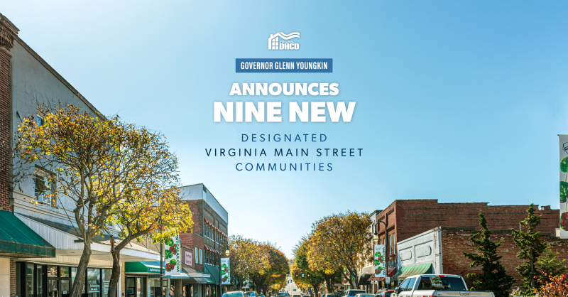 A blue sky over a downtown street. Text reads "Governor Glenn Youngkin Announces Nine New Designated Virginia Main Street Communities "